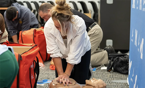 Teacher practicing CPR in a workshop