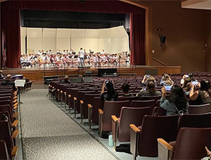 students on stage performing on stage in a theater